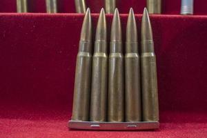 many war gun bullets close up on red photo