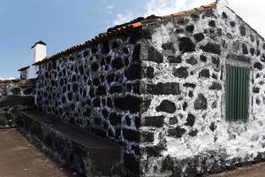 Lajido village Pico Island Azores black lava houses red windows photo