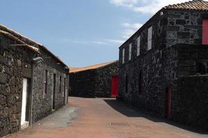 Lajido village Pico Island Azores black lava houses red windows photo