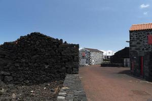 Lajido village Pico Island Azores black lava houses red windows photo