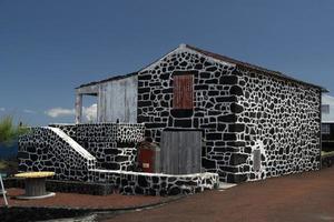 Lajido village Pico Island Azores black lava houses red windows photo