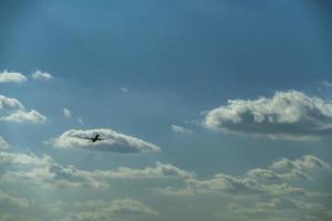 airplane taking off in cloudy sky photo