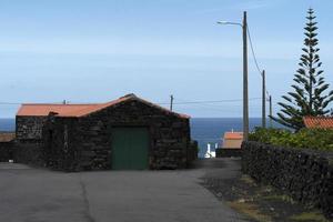 Lajido village Pico Island Azores black lava houses red windows photo