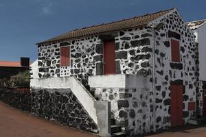 Lajido village Pico Island Azores black lava houses red windows photo