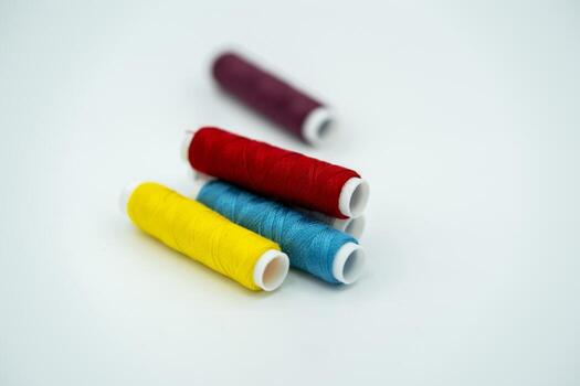spool of thread many of different colors isolated on white photo