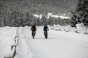 Cycling in the snow in dolomites photo