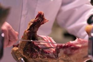 Hands while cutting spanish ham photo