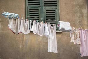 clothes hanging outside house drying to the sun photo