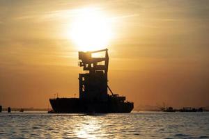 grain silos descharghing ship at Sunset in Venice lagoon chioggia harbor photo