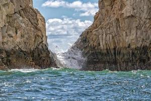 waves on lava rocks in cabo san lucas mexico photo