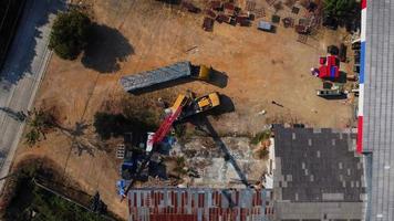 une grue mobile attend de soulever de l'acier dans un entrepôt. grutiers et grues mobiles travaillant sur un chantier de construction. video