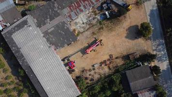 Mobile crane stands waiting to lift steel at a warehouse. Crane operators and mobile cranes working at a construction site. video