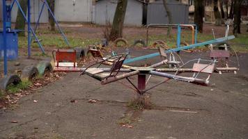 An old carousel rotates in the playground video