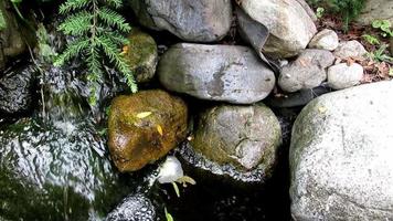 small fountain stream running down the rocks video