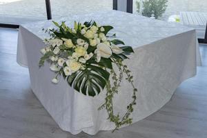 white rose bride bouquet close up detail on wedding table photo