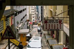 Hong Kong,March 25,2019-people among the skyscrapers through the streets of Hong Kong during a cloudy day photo