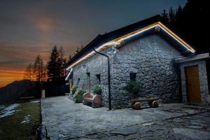 Illuminated mountain hut photo