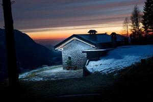 Illuminated mountain hut photo