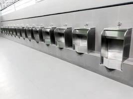 Perspective view and modern design of men urinal in public toilet. Designed and made from stainless steel to prevent rust And modern look. photo