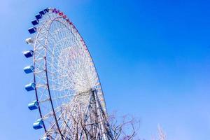 Closeup and crop Tempozan Giant Ferris Wheel on bright blue sky background with space for texts. photo