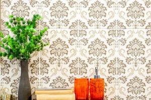 Ornamental plants in a black vase with two orange glass on red marble shelves and front of flowers pattern tile in the toilet. with space for texts. photo