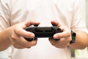 Black joystick in hands isolated on white background. Computer gaming technology play competition video game control confrontation concept. esport concept. photo