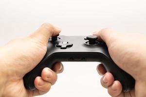 Black joystick in hands isolated on white background. Computer gaming technology play competition video game control confrontation concept. esport concept. photo