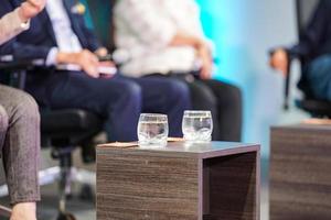 se prepara un vaso de agua para el orador y la sesión de debate en el escenario foto