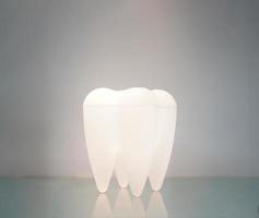 Teeth lamp stand on the mirror ground. photo