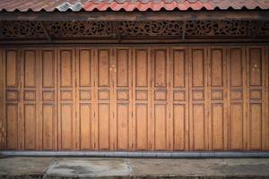 Classic backdrop wood wall and door in front of Thailand vintage traditional Building. photo
