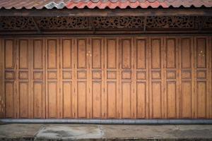 Classic backdrop wood wall and door in front of Thailand vintage traditional Building. photo