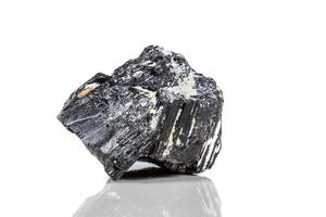 macro mineral stone sherle, schorl, black tourmaline on white background photo