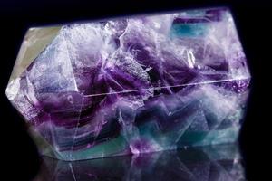 Macro mineral stone Fluorite crystal on a black background photo