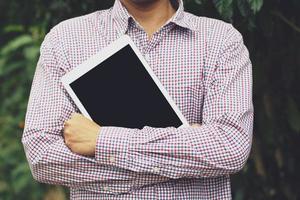 Business man stand hug tablet. or students prepare to learn. photo