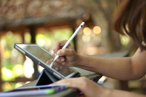 Female hand working looking at plan on computer in cafe photo