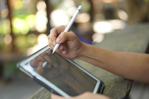 Female hand working looking at plan on computer in cafe photo