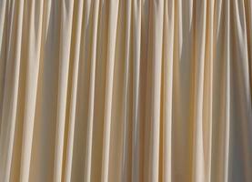 Background Yellow curtains lined in waves. photo