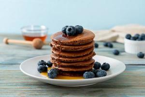 chocolate pancake stack with blueberry and honey photo