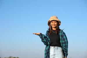 Asian female farmer uses computer to analyze rice growth. photo