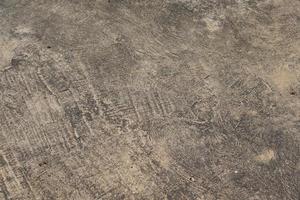 el piso de cemento tiene grietas y patrones. foto
