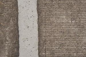 The cement floor has cracks and patterns. photo