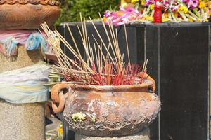 Clay pots with many incense sticks to worship the Buddha photo