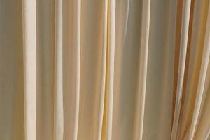 Background Yellow curtains lined in waves. photo