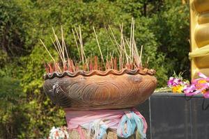 Clay pots with many incense sticks to worship the Buddha photo