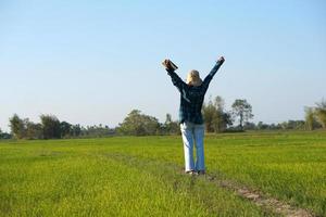 Asian female farmer delighted with rice growth target. Computer analysis photo