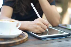 Female hand working looking at plan on computer in cafe photo