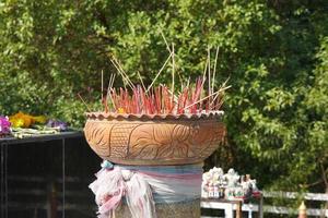 Clay pots with many incense sticks to worship the Buddha photo