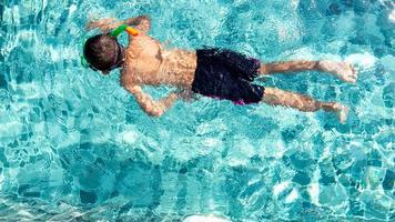 Boy having fun playing in the pool photo