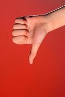 Close-up of a hand with a fingernail up of an isolated on a red background photo