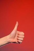 Close-up of a hand with a fingernail up of an isolated on a red background photo